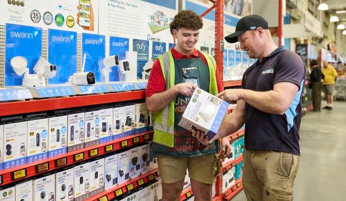 a team member and customer interacting in a store aisle