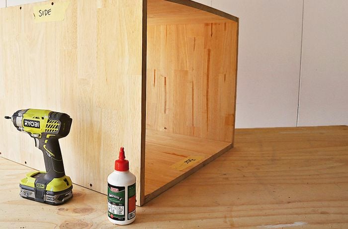 A drill and glue is used to assemble bedside table frame