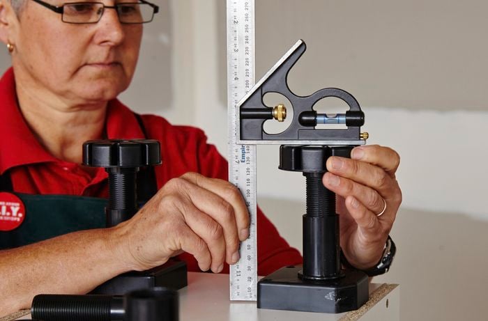 Person adjusting cabinet feet height
