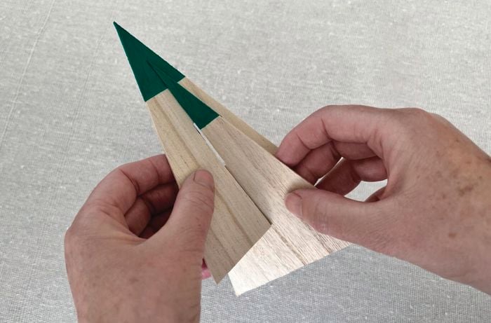 Hands build slot paper triangles into one another