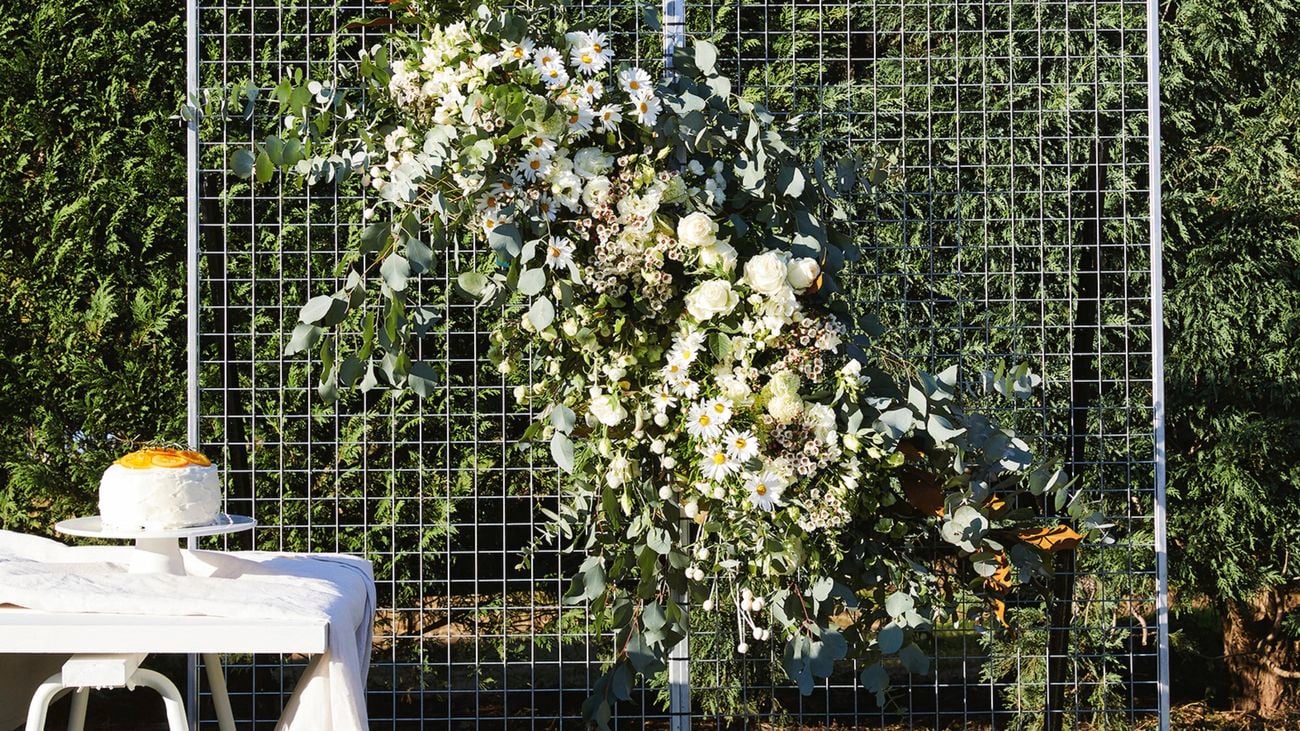 Use a few plain wire mesh panels with a host of flowers to make your own simple floral screen.