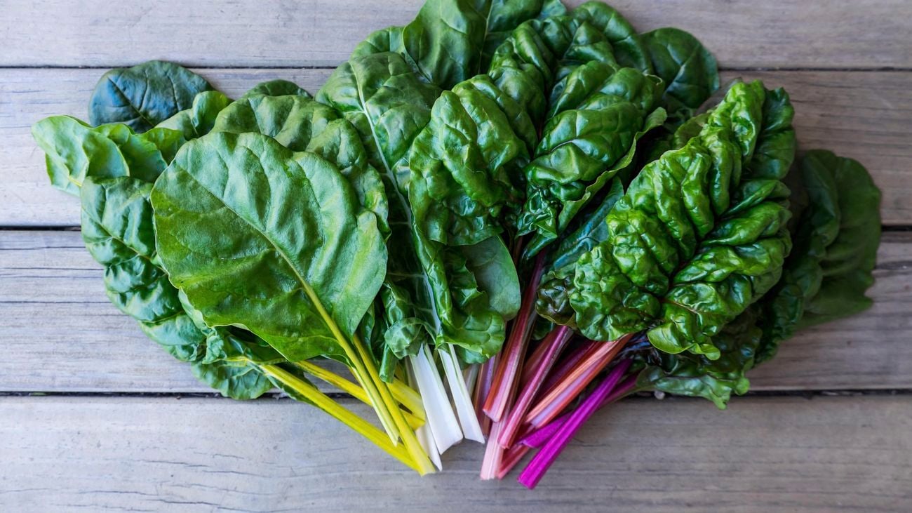 Silverbeet leaves on a wooden table