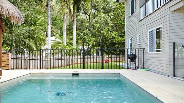 A pool with a pool fence.