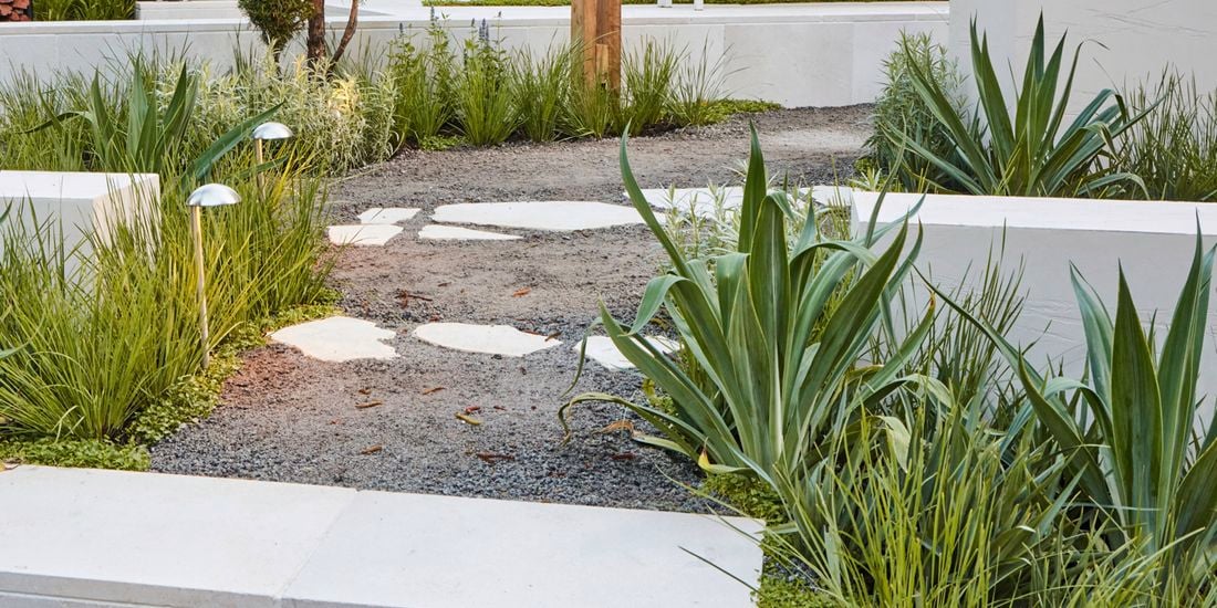 A diverse mix of materials including rocks, brick and stone pavers in a garden