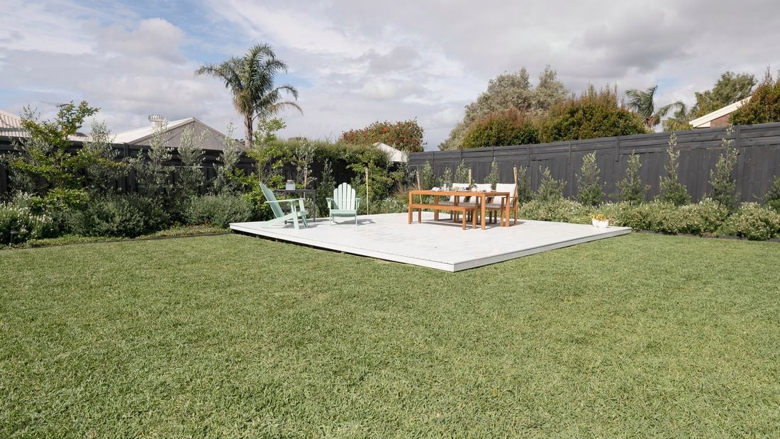 Sprawling green lawn with outdoor furniture.