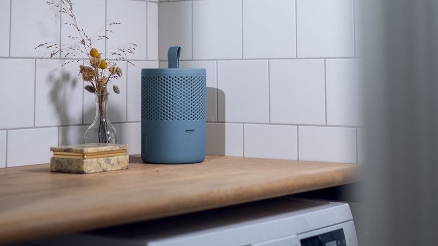 Stylish Blue moisture absorber sitting on alaundry bench