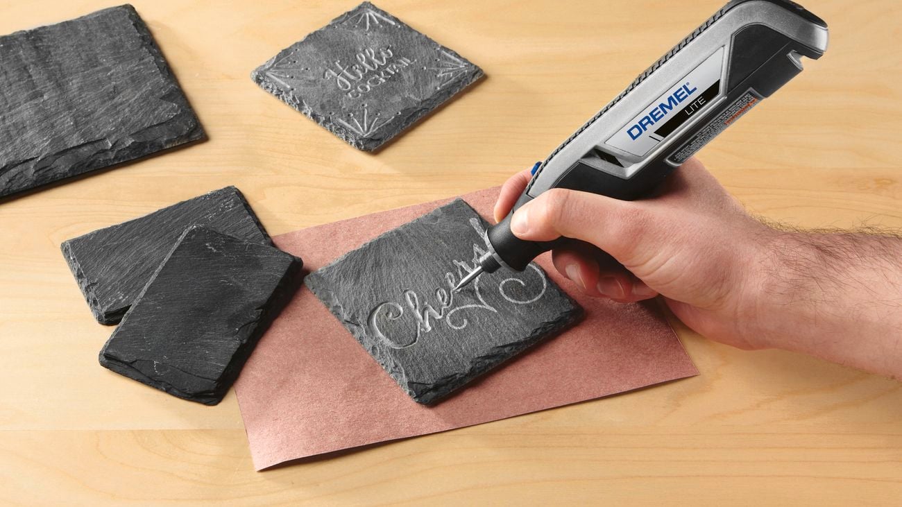 Dremel carving tool engraving a piece of slate