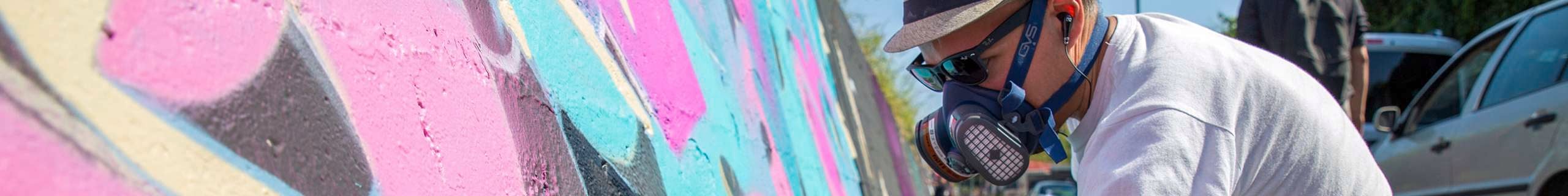 GVS header image with person in the branded PPE painting a wall
