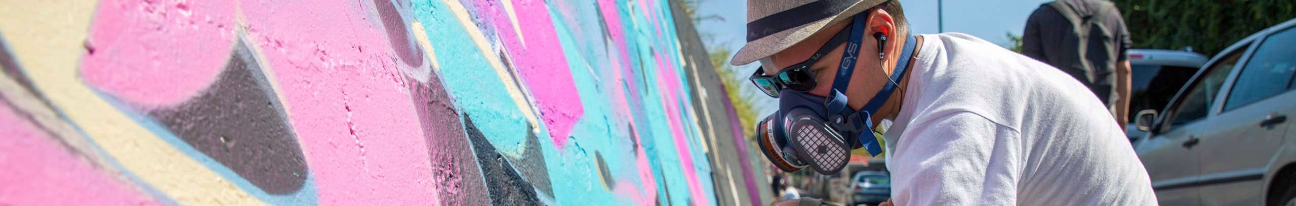 GVS header image with person in the branded PPE painting a wall