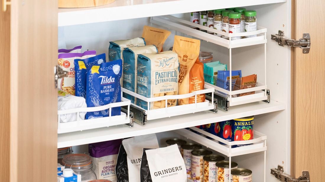 Organised pantry cupboard featuring pull-out storage drawers and shelves