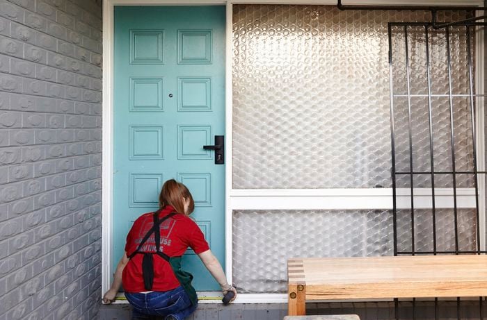 A Bunnings team member measuring the size of a door frame