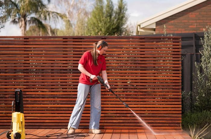 Cleaning the patio with a pressure washer