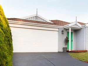 Front of a house, showing garage door.