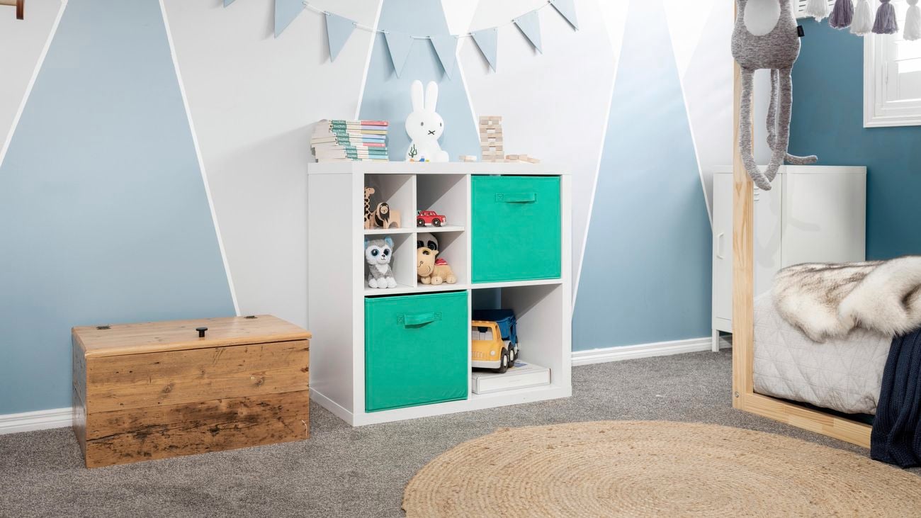 Kids bedroom with a storage cube that houses toys.