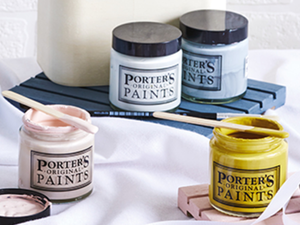 Painted Easter eggs and paint tubs on a silk sheet.