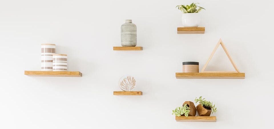 Floating shelves with indoor pot plants and jars
