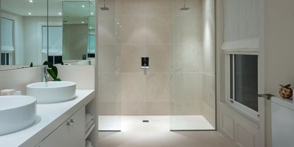 Bathroom with double shower and double basin and white walls