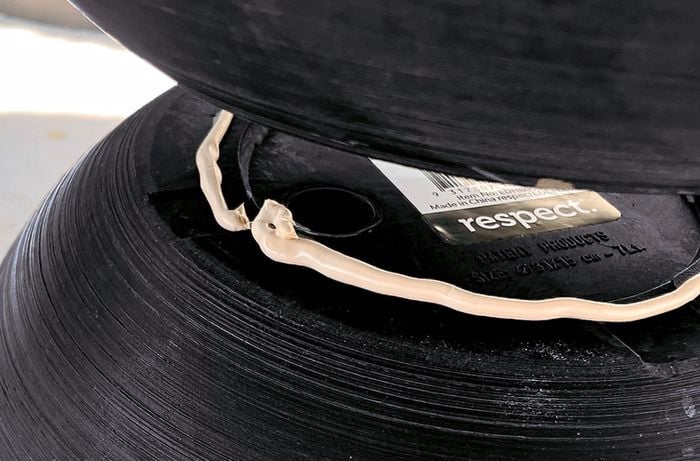 Construction adhesive on the rims of the bases of planters
