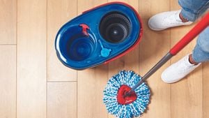 Birds-eye view shot of a blue mop bucket and spin mop on hardwood floors