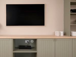 Image of a mounted TV with hidden cables using grommets.