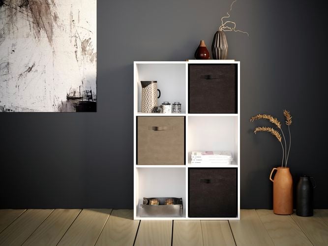 A cube shelving unit on wooden flooring with a picture on the wall
