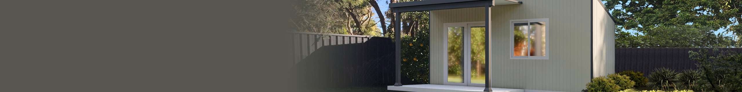Cream cabin in a backyard with dark coloured in-built gazebo.
