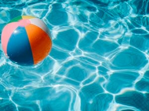 Beach ball in swimming pool.