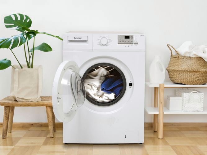 Front loader washing machine with towels.
