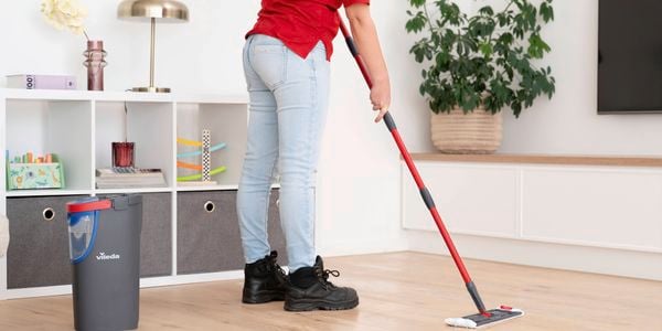Bunnings team member mopping the kitchen timber flooring