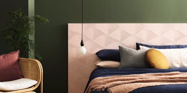 Bedroom with hanging light beside bed.