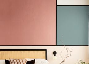   A close up of a wall in a bedroom using colour block interior design with two different colours.