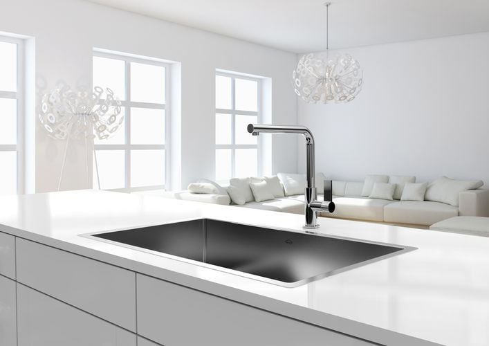 White kitchen benchtop with stainless steel sink and tapware