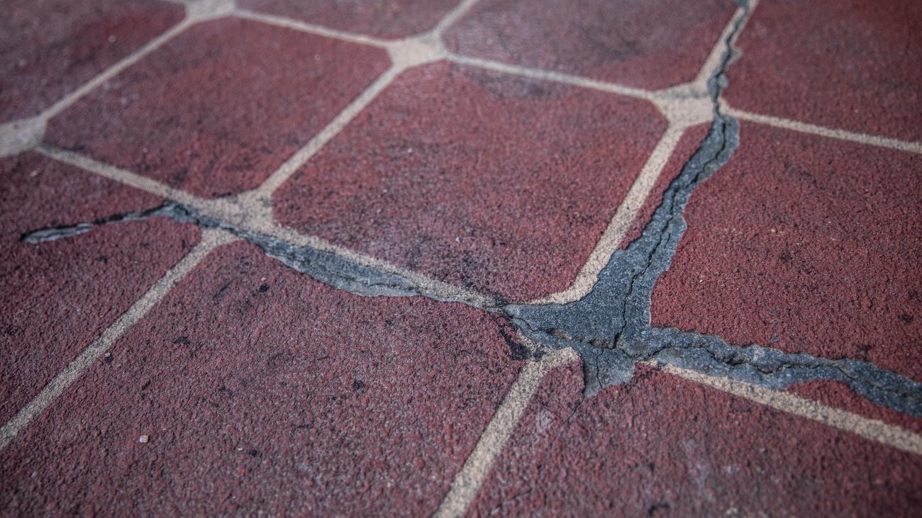 Driveway with cracks running along the images in preparation to be fixed 