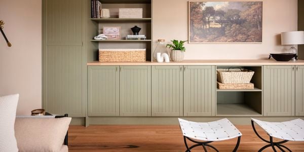 Cabinet indoors with timber top, timber shelving with artwork in the back ground