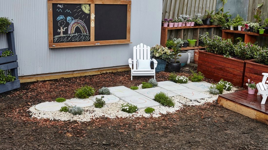 Hopscotch court made from concrete pavers in a backyard
