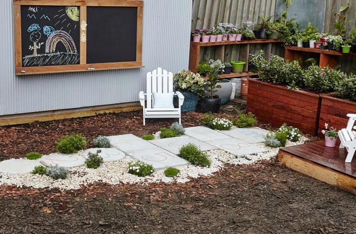 Hopscotch court made from concrete pavers in a backyard