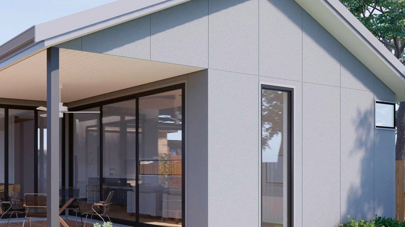 Exterior of house with patio, with grey cladding.
