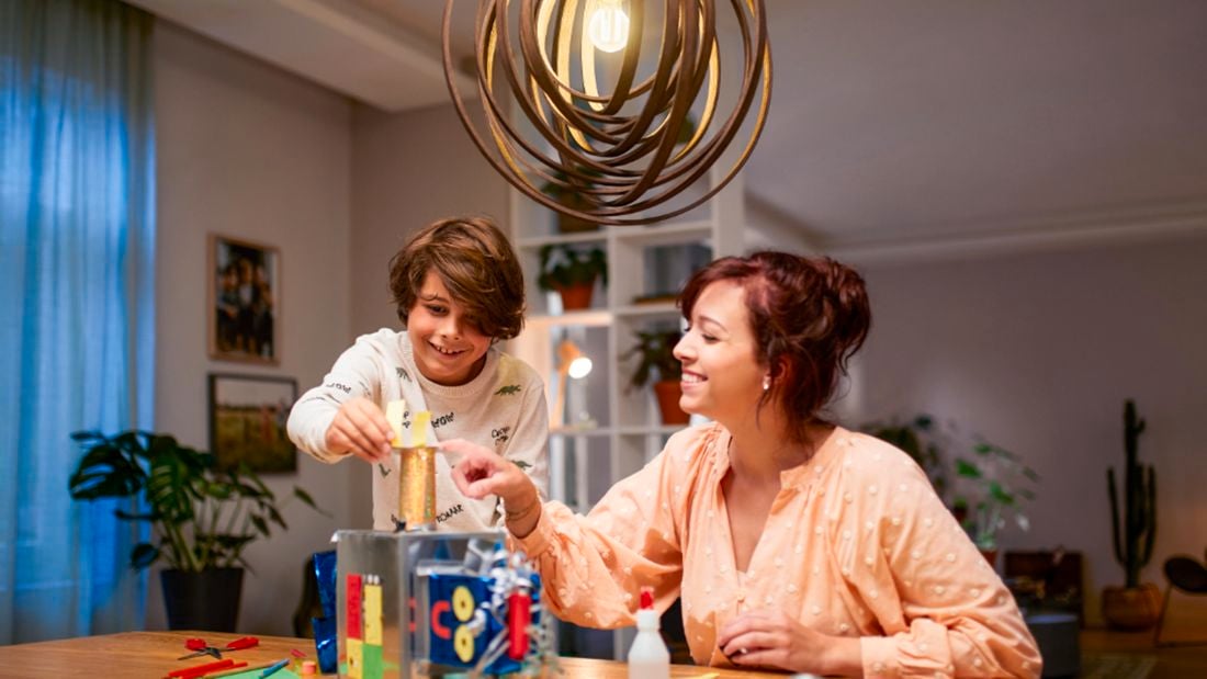 Mom and son building a castle under light