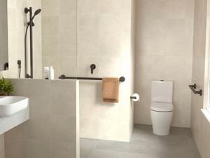A contemporary tiled bathroom featuring black HomeCare by Caroma fixtures and fittings