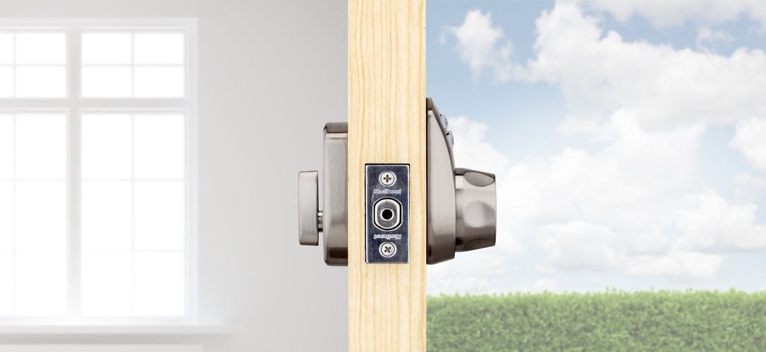 Side view of front door showing exterior and interior of front door lock