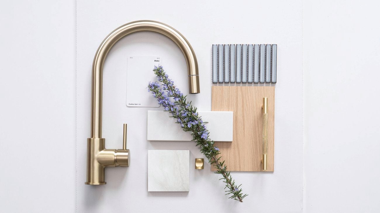 Natural Neutrals flatlay with brass tap, light oak, white tiles, grey mosaic, and rosemary 