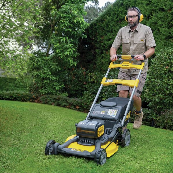 Person using a DEWALT Lawn mower on grass