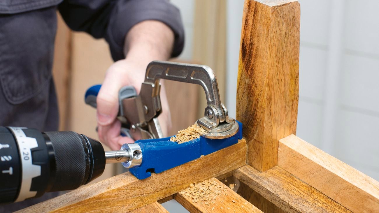 A person using a Kreg 310 pocket-hole jig