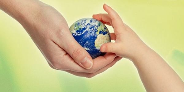 Hands touching mini world globe.