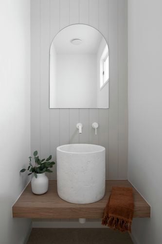 Bathroom vanity, sink and mirror in view with a wall painted with Coloursmith