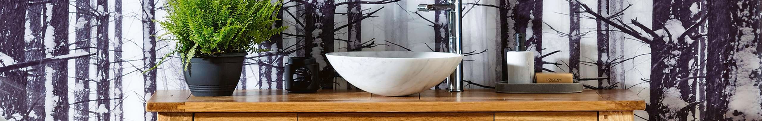Bathroom with freestanding timber vanity, circle mirror and wallpaper