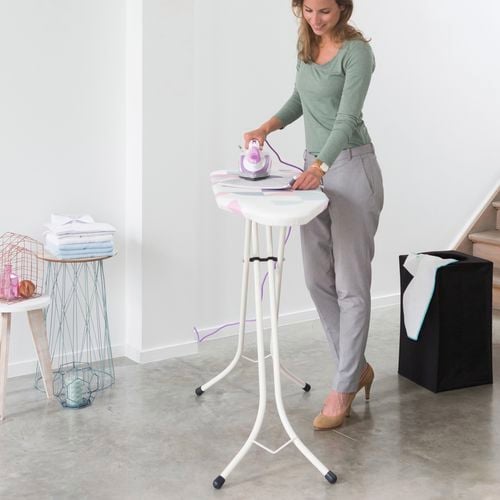 Lady ironing in her living room in comfort