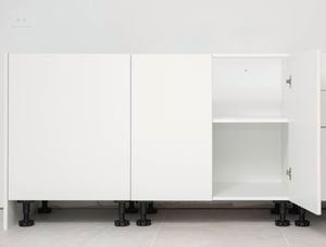 White base cabinet with multiple sections and inner shelves installed.