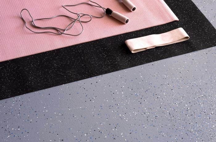 Gym equipment on a garage floor. Dy-Mark epoxy flooring finish in Slate with speckles