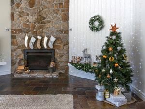 Small tree set up in room with fireplace